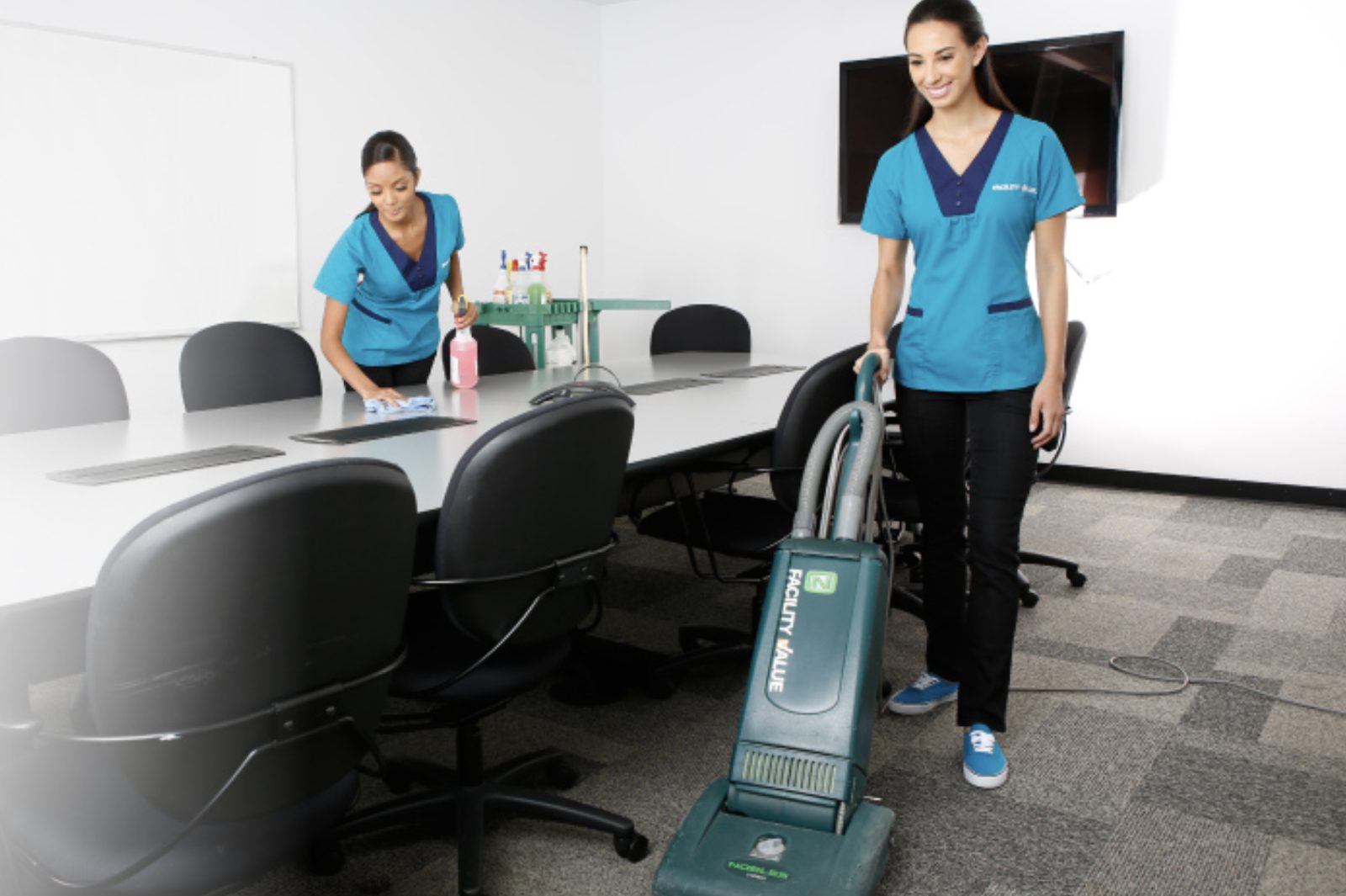 Facility Value staff cleaning a conference room carpet