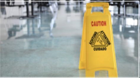 Wet floor caution sign in a polished lobby