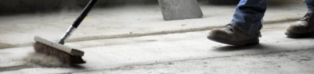 Broom sweeping construction dust
